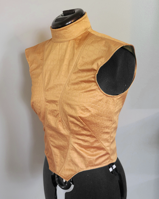 Gold dragon scale patterned vest on a mannequin against a plain background
